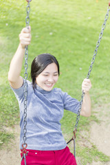 Woman Playing on the Swings