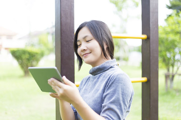 Woman Use Tablet for Relaxation at Playground