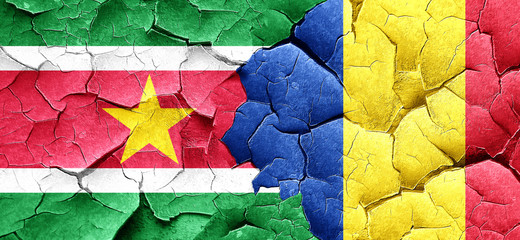 Suriname flag with Romania flag on a grunge cracked wall