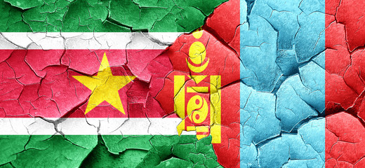 Suriname flag with Mongolia flag on a grunge cracked wall