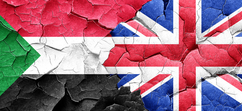 Sudan flag with Great Britain flag on a grunge cracked wall