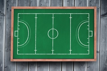 Handball field plan on a black background against blackboard with copy space on wooden board