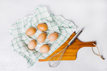 Raw organic brown eggs over napkin