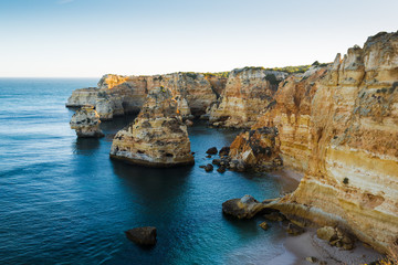 Lovely evening with a view of the ocean and cliffs. Praia da Marina. Region Algarve. Portugal