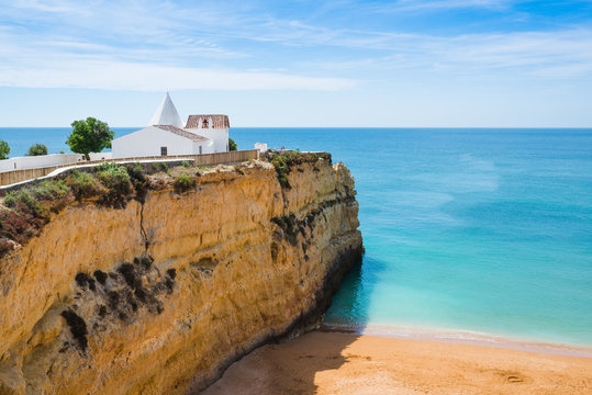 The Chapel of Nossa Senhora da Rocha on top of the spectacular cliffs on Nova Beach. Region Algarve. Portugal
