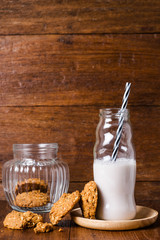 Stack of whole grains cookies with milk bottle
