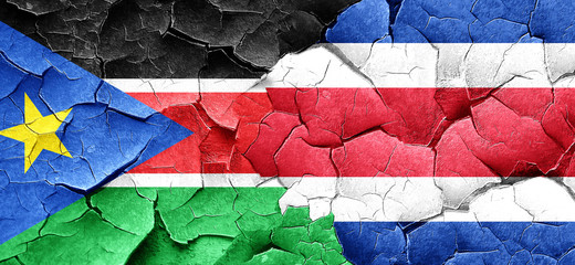 south sudan flag with Costa Rica flag on a grunge cracked wall