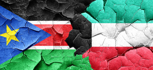 south sudan flag with Kuwait flag on a grunge cracked wall