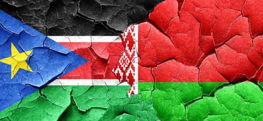 south sudan flag with Belarus flag on a grunge cracked wall