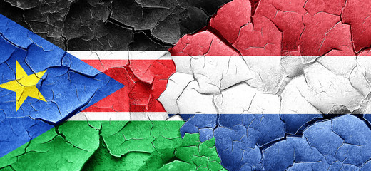 south sudan flag with Netherlands flag on a grunge cracked wall