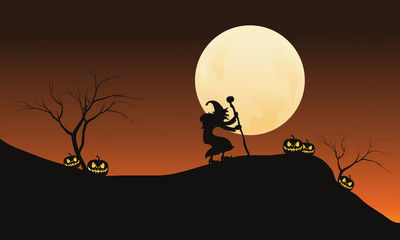 Halloween witch and full moon in hills