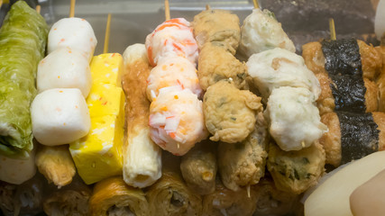 The close up of Taiwanese oden meat balls on stick at food street night market in Taipei, Taiwan.