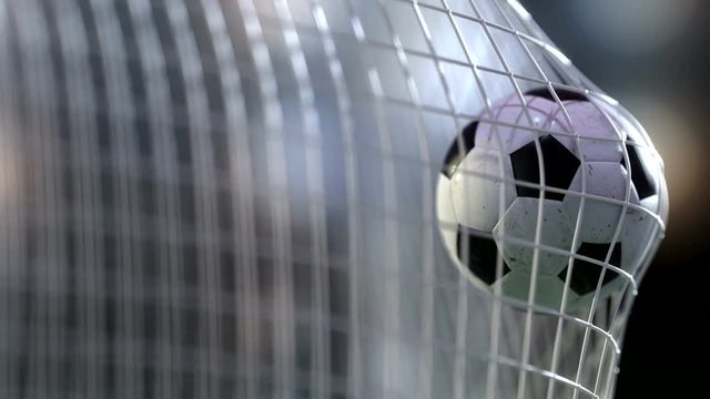 soccer ball in goal net with slowmotion. Slowmotion football ball in the net.