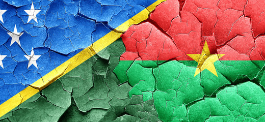 Solomon islands flag with Burkina Faso flag on a grunge cracked