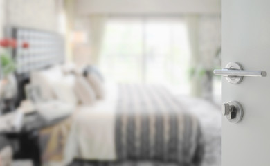 opened white door to modern bedroom interior