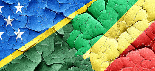 Solomon islands flag with congo flag on a grunge cracked wall