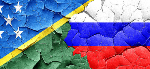 Solomon islands flag with Russia flag on a grunge cracked wall