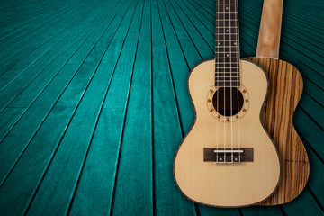 Obraz premium Part of a blue acoustic guitar on a wooden background.