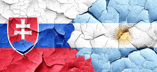 Slovakia flag with Argentine flag on a grunge cracked wall