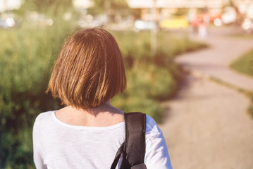 Casual young adult woman walking on city streets