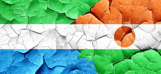 Sierra Leone flag with Niger flag on a grunge cracked wall
