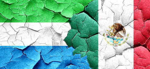 Sierra Leone flag with Mexico flag on a grunge cracked wall
