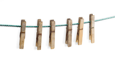 Old spring type wooden clothespin on a light background