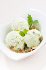 pistachio ice cream in a bowl, vertical, closeup