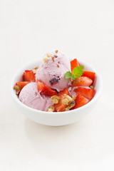 strawberry ice cream in a bowl, vertical