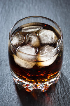 cola with ice in a glass, vertical top view