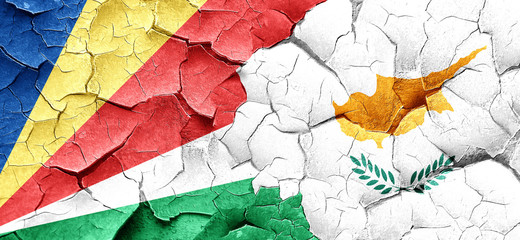 seychelles flag with Cyprus flag on a grunge cracked wall