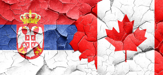 Serbia flag with Canada flag on a grunge cracked wall