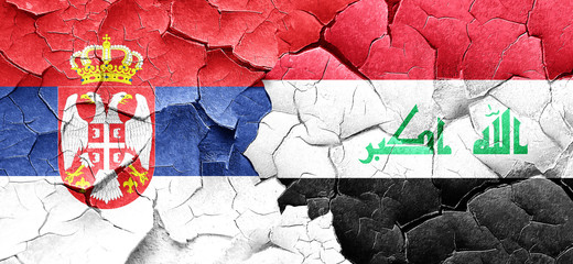 Serbia flag with Iraq flag on a grunge cracked wall