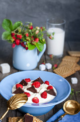 Wild strawberry with cream, cookies and milk, the old rough boards.