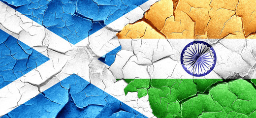 scotland flag with India flag on a grunge cracked wall