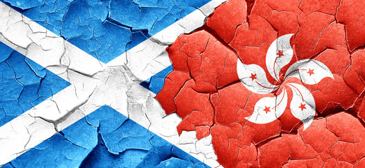 scotland flag with Hong Kong flag on a grunge cracked wall