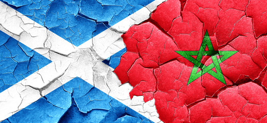 scotland flag with Morocco flag on a grunge cracked wall