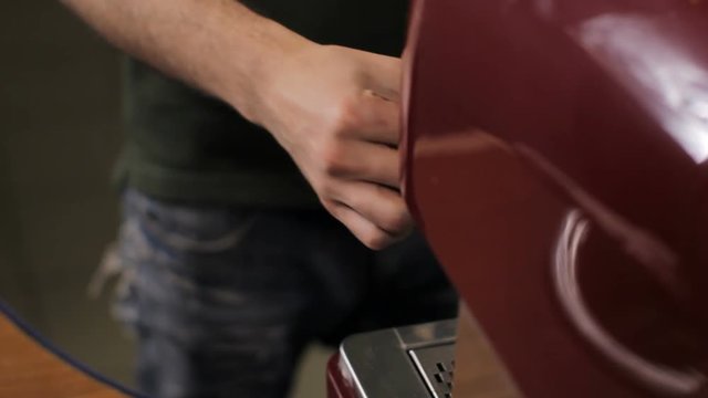 Barista cleans the steam arm up. Close up
