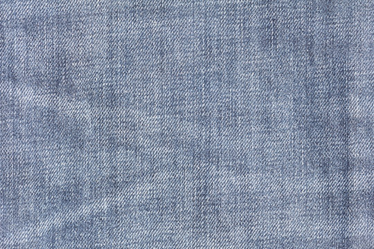 Closeup denim jeans texture. Stitched textured blue denim jeans background. Old grunge vintage denim jeans. Denim jeans fashion design.