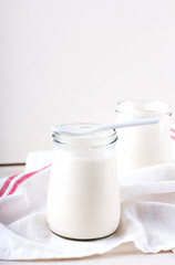 organic dairy products (yogurt, sour cream) in a glass jar