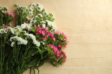 two bouquets of chrysanthemum on white wooden background