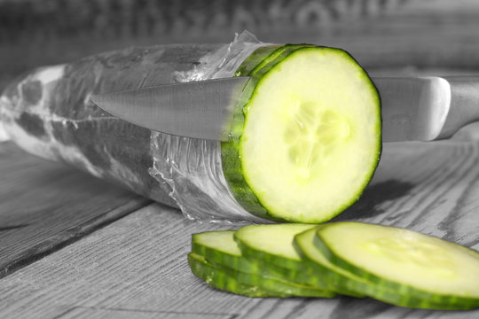 Cucumber slicing / Abstract image of a cucumber being sliced using selective color
