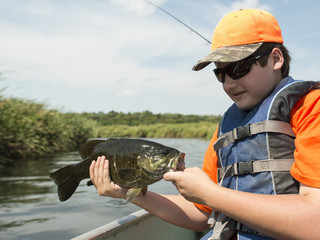 A young fisherman with a Small Mouth Bass