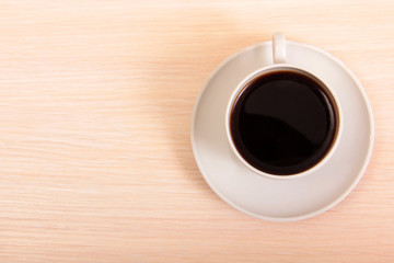 Coffee beans and a white cup on table