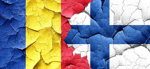 Romania flag with Finland flag on a grunge cracked wall