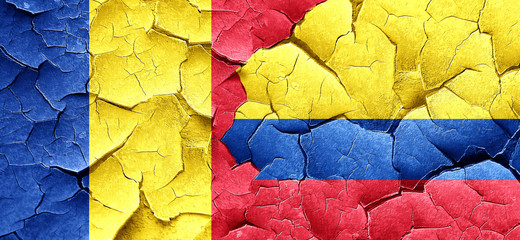 Romania flag with Colombia flag on a grunge cracked wall
