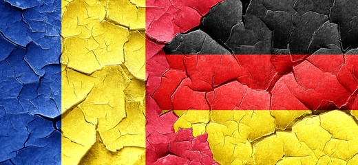 Romania flag with Germany flag on a grunge cracked wall