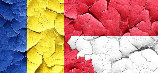Romania flag with Indonesia flag on a grunge cracked wall