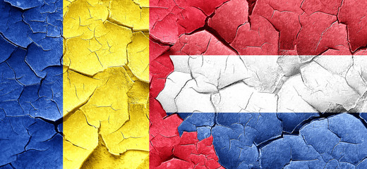 Romania flag with Netherlands flag on a grunge cracked wall