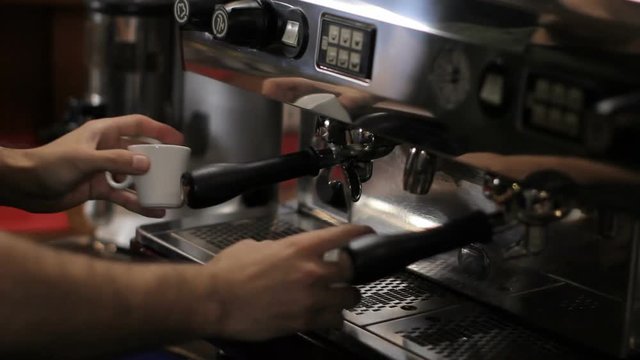 Barista prepares two cups of espresso. Medium shot